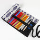 Open canvas pencil roll with colorful pencils in rows and dark elastic separators