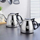 Stainless steel kettles set with black handles and lids, small and larger teapot on table