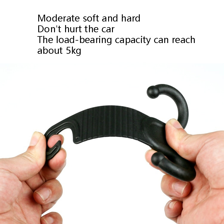 Car headrest luggage hook held by hands, black ridged hook for securing items