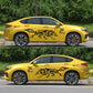 Black wolf totem decals on a yellow car door and rear quarter panel
