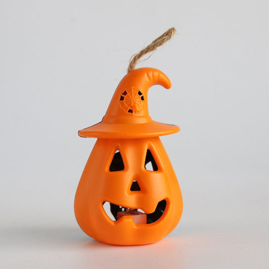 Orange pumpkin lantern ornament with witch hat and carved jack-o-lantern face cutouts