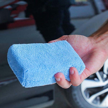 Blue microfiber sponge cloth, rectangular, held in hand for car washing and polishing