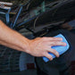 Blue microfiber sponge cloth wiping dark car body panel