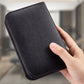 Black manicure tool case held in hand with stitched texture for nail clipper set storage