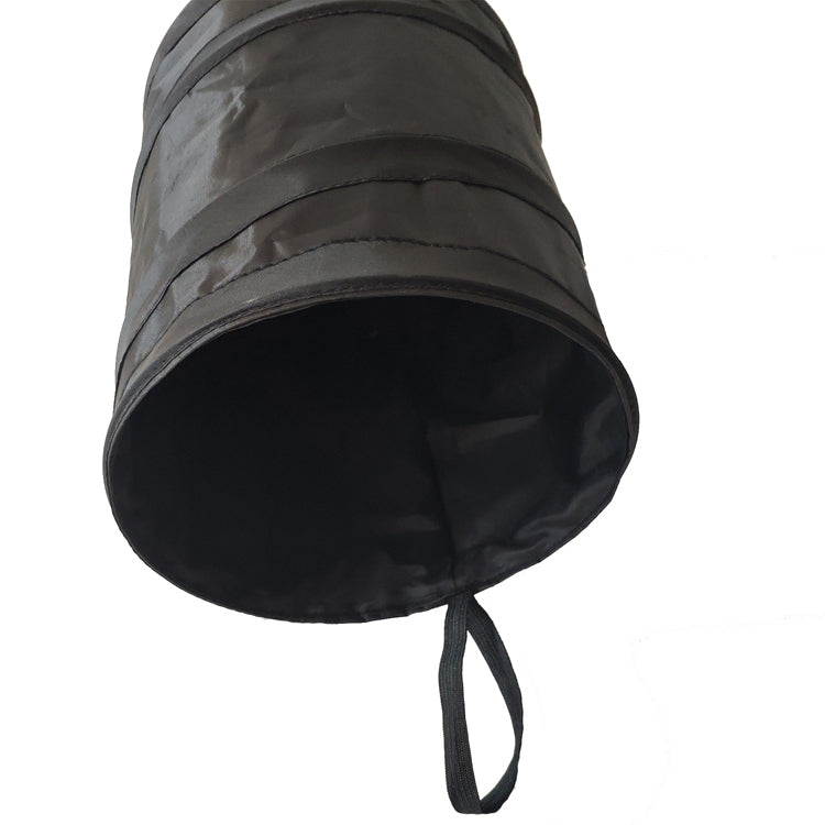 Foldable black trash bin with open rim and hanging drawstring handle.
