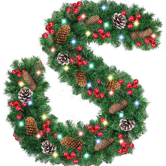 Green Christmas wreath garland with pinecones, red berries, and warm LED lights
