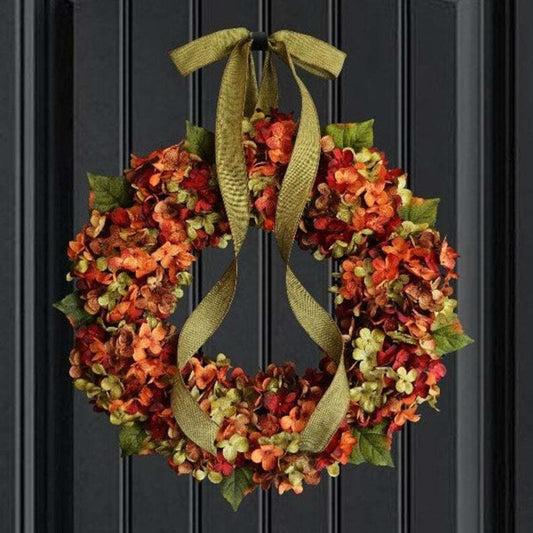 Artificial hydrangea wreath with long green ribbon loops, orange and yellow-green blossoms