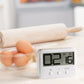 Close-up LCD countdown timer displaying digits with three control buttons