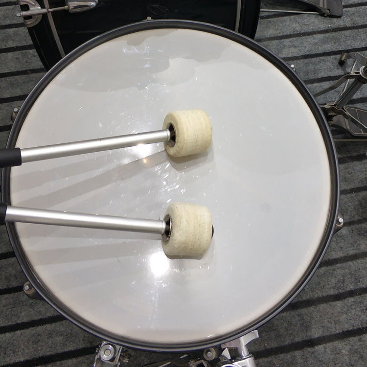 Drum hammers striking a kick drum head; felt mallet heads on metal shafts