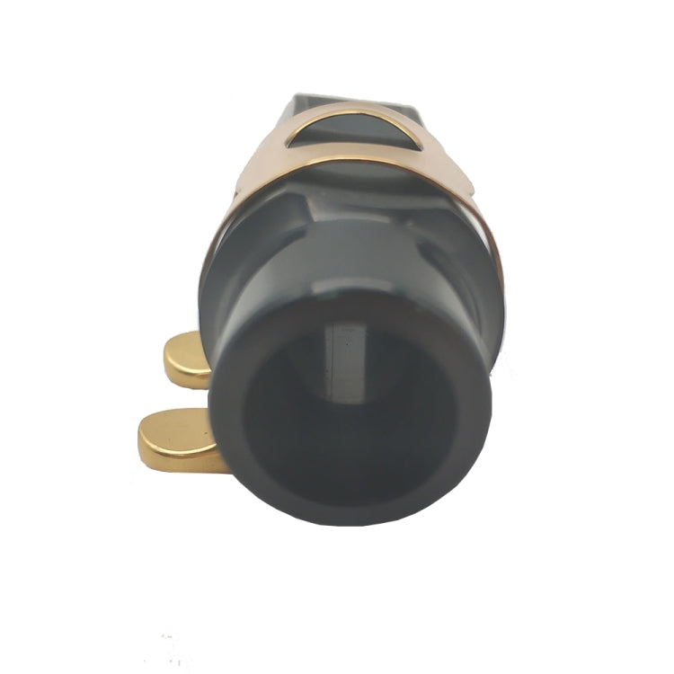 Close-up of black saxophone mouthpiece end with gold-tone ligature and clip