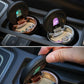 Two open mini car ashtrays with cigarette holders and colored indicator lights