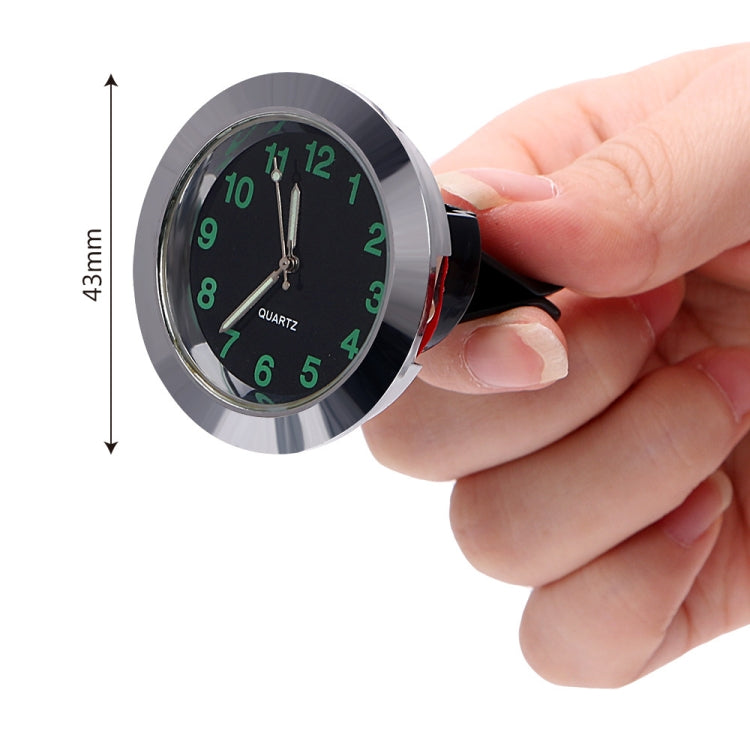 Car night light quartz clock being installed, black face with green illuminated numbers
