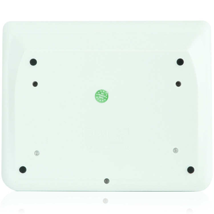 Back of a white calculator with screw mounts and a small green label