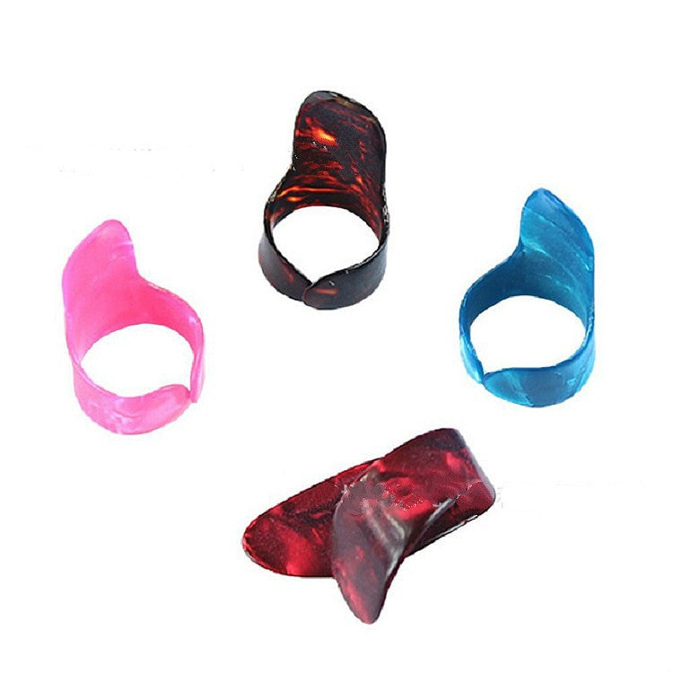 Colored guitar finger picks set with pink, blue, and red translucent designs