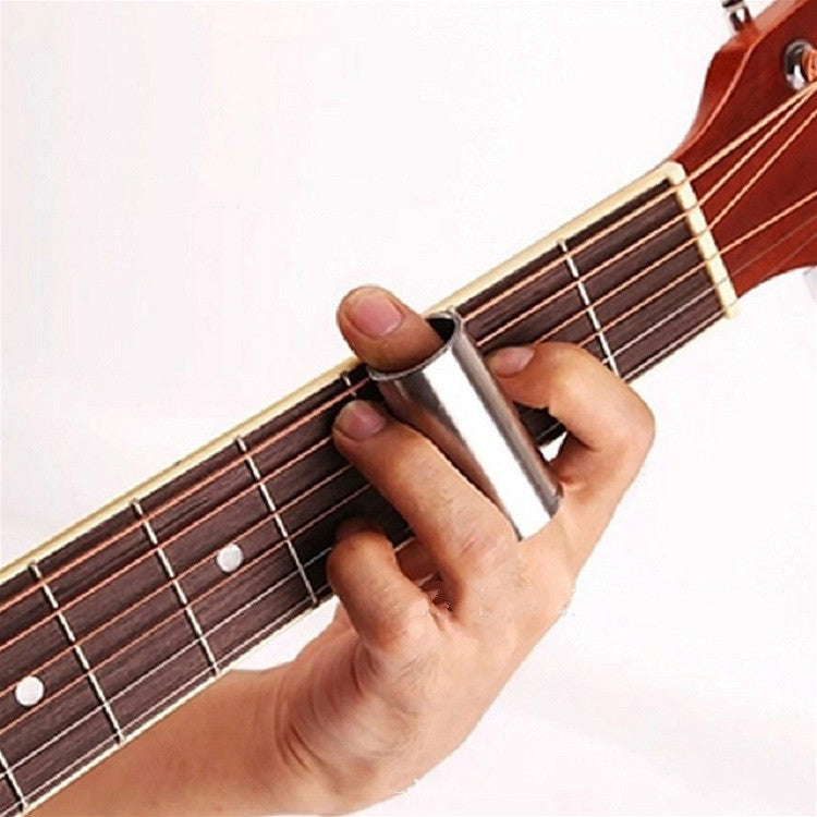 Guitar slide bar in use on guitar strings between two hands
