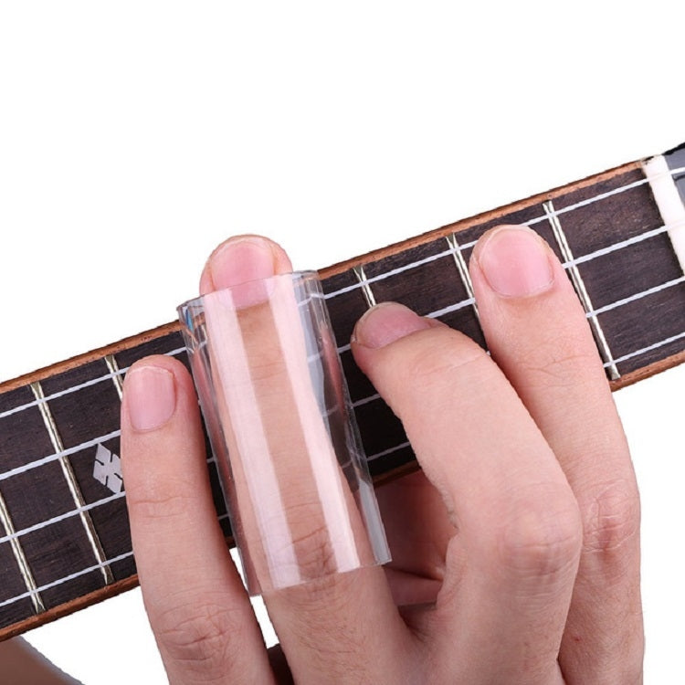 Hand wearing a clear guitar slide bar over guitar strings