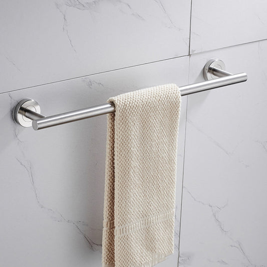 Stainless steel bathroom towel rod with wall mounts holding a beige towel