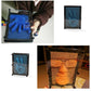 Blue bead hand mold in a clear frame, shown being used to create a handprint