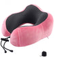 Pink U-shaped memory foam travel pillow with dark center panel and adjustable cords
