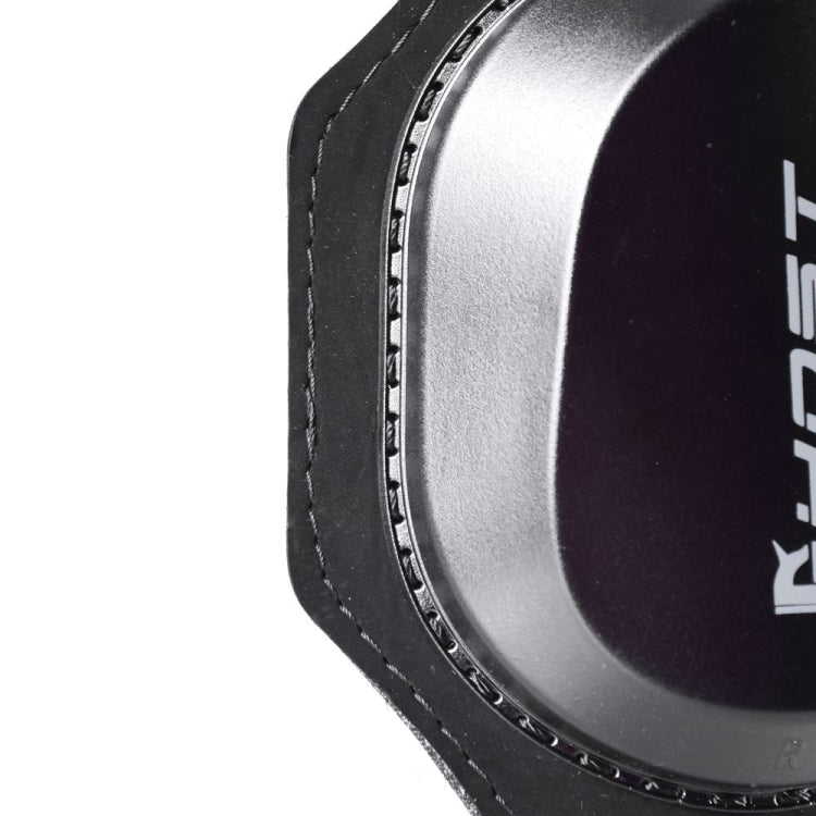 Close-up side view of black knee protector with curved plastic cap and stitched rim