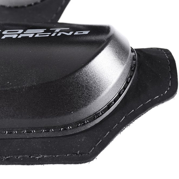 Close-up of black knee protector edge with reinforced plastic cap and stitch trim