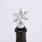 Snowflake champagne stopper with chrome star topper and black rubber bottle insert