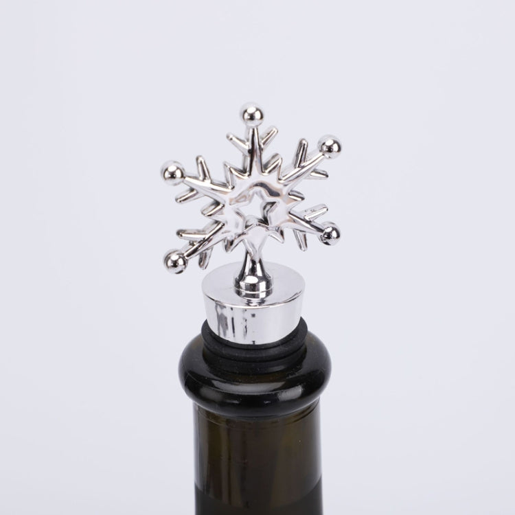 Snowflake champagne stopper with chrome star topper and black rubber bottle insert