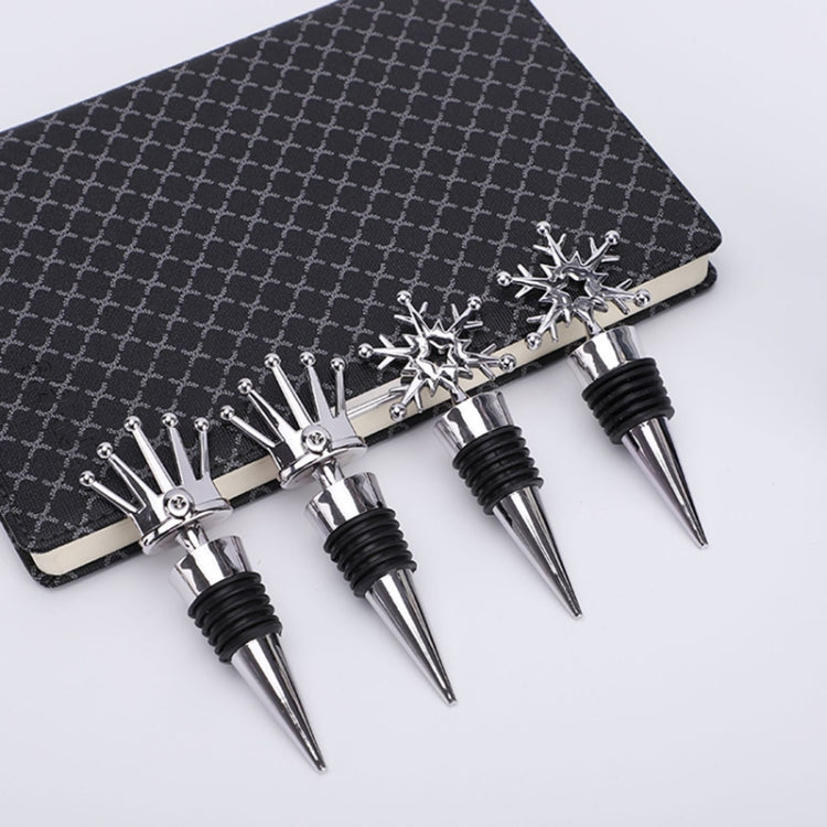 Set of snowflake champagne stoppers on display card, chrome tops with black rubber rings