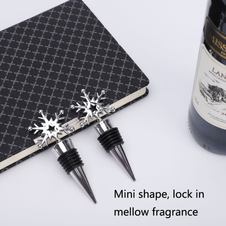 Set of snowflake champagne stoppers, chrome star finials with black rubber rings