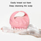 Pink silicone scalp brush used on hand with visible soap foam and bristles