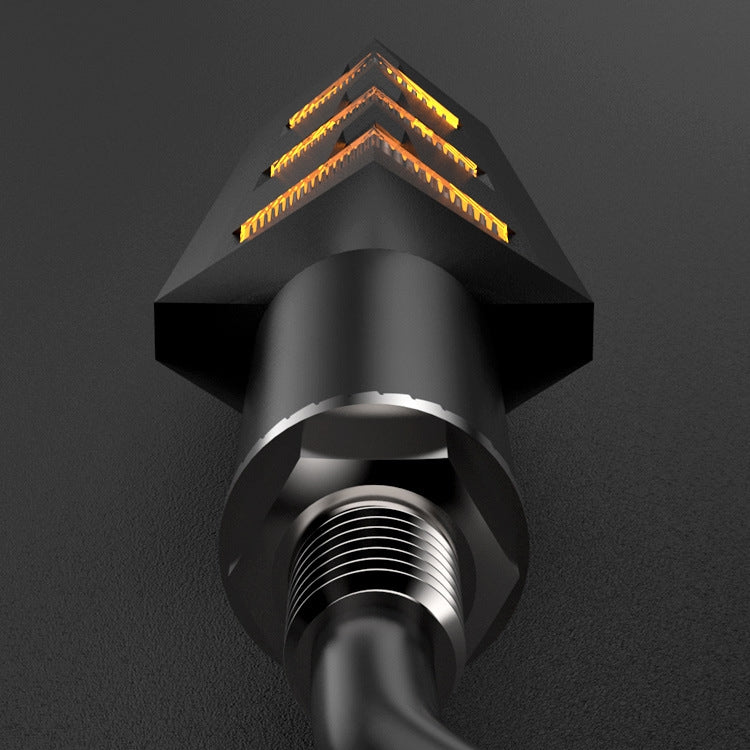 Amber LED turn signal lamp close-up showing layered arrow light through lens