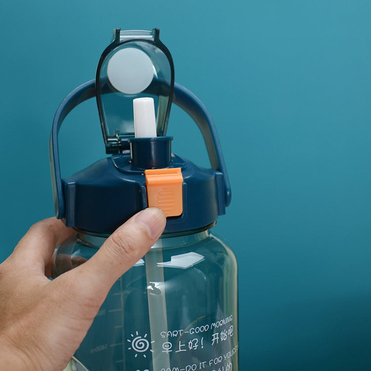 Sports water bottle with straw lid and orange release latch, held by hand
