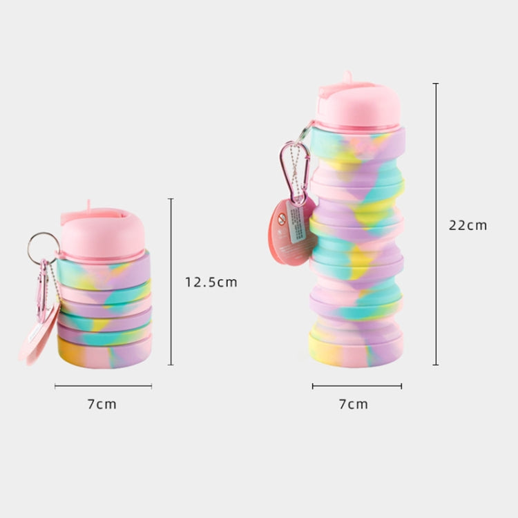 Collapsible silicone travel cup with rainbow folds, pink lid, carabiner, about 22 cm tall