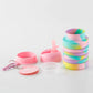 Foldable silicone water cup set with rainbow body, pink caps, straw lid, and spare parts