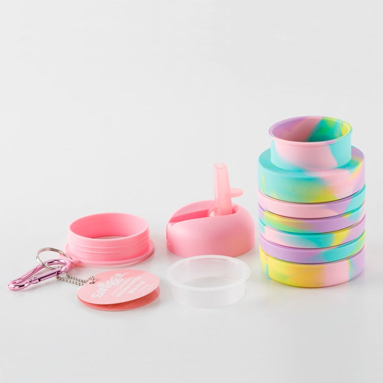 Foldable silicone water cup set with rainbow body, pink caps, straw lid, and spare parts