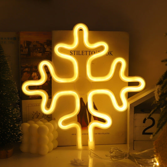 Neon snowflake wall decoration with warm white glow, snowflake-shaped frame.
