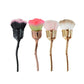Set of loose powder makeup brushes with black, pink, peach, and beige bristle heads