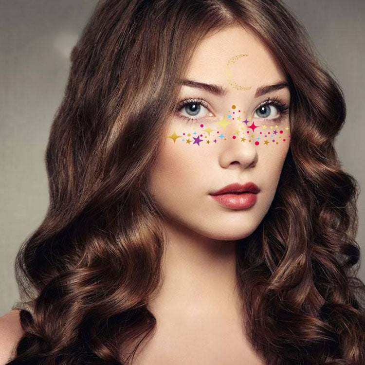 Woman with colorful star and dot face tattoo stickers across forehead and nose