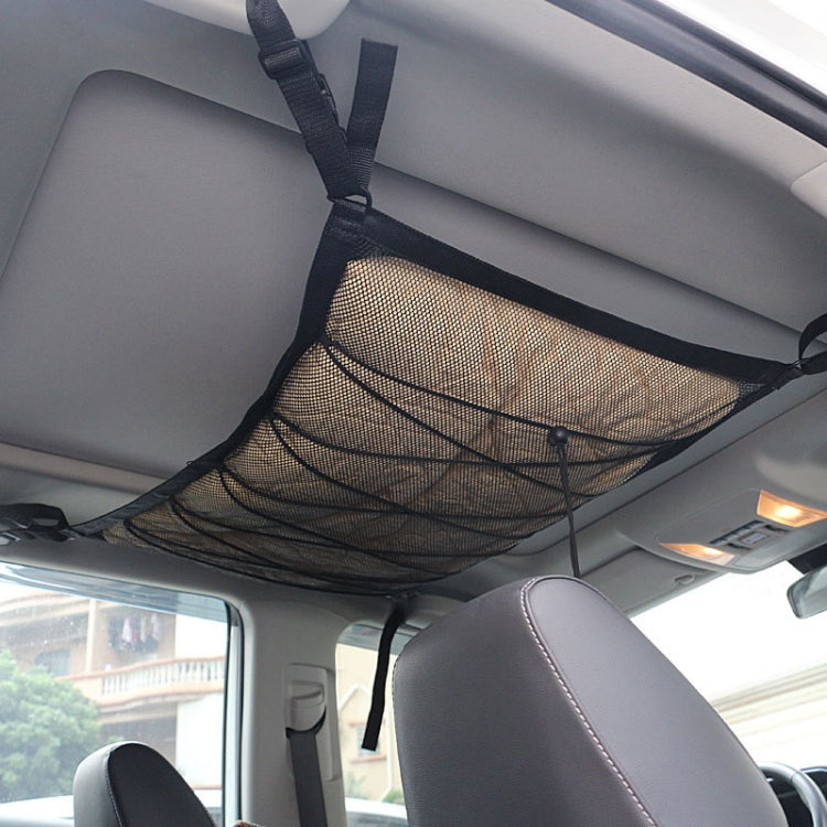 Black car ceiling net storage bag with hanging straps over the back seat