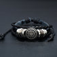 Black leather wrap bracelet with braided cord and central round floral charm in silver