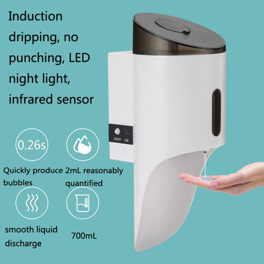 Automatic soap dispenser with white body and dark lid; hand near front dispensing area