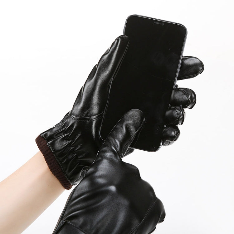 Black gloves on hand with plush wrist lining holding a smartphone