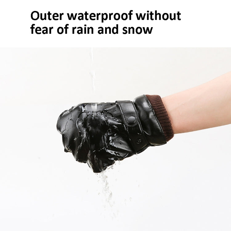 Black waterproof winter gloves on wrist with water droplets on leather