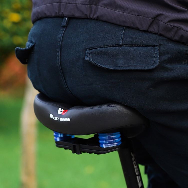 Mounted bicycle suspension saddle with visible blue springs under the seat