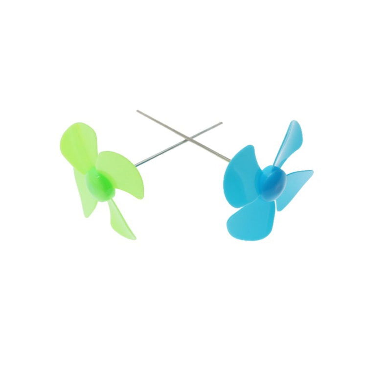 Green and blue four-blade propellers on metal axles