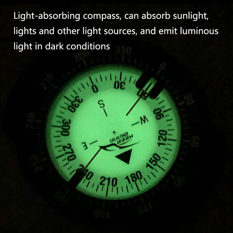 Luminous green diving compass face glowing in dark conditions