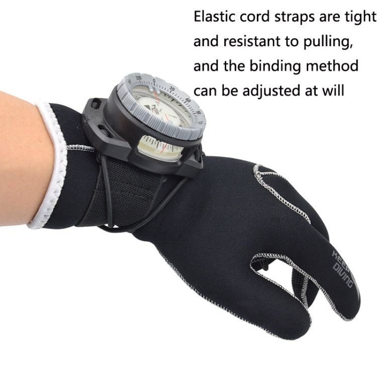 Diving compass with elastic cord strap worn over black glove