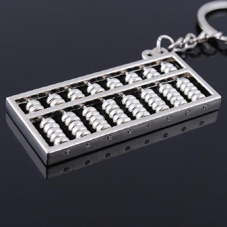 Silver abacus keychain pendant with key ring, close-up of bead rows in metal frame