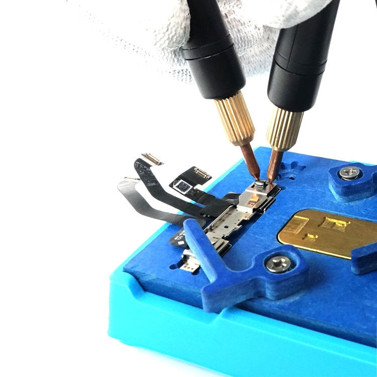 Spot welding pen tips welding battery contacts on a blue fixture