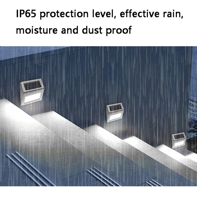 Stainless solar LED stair wall light illuminating steps under wet weather